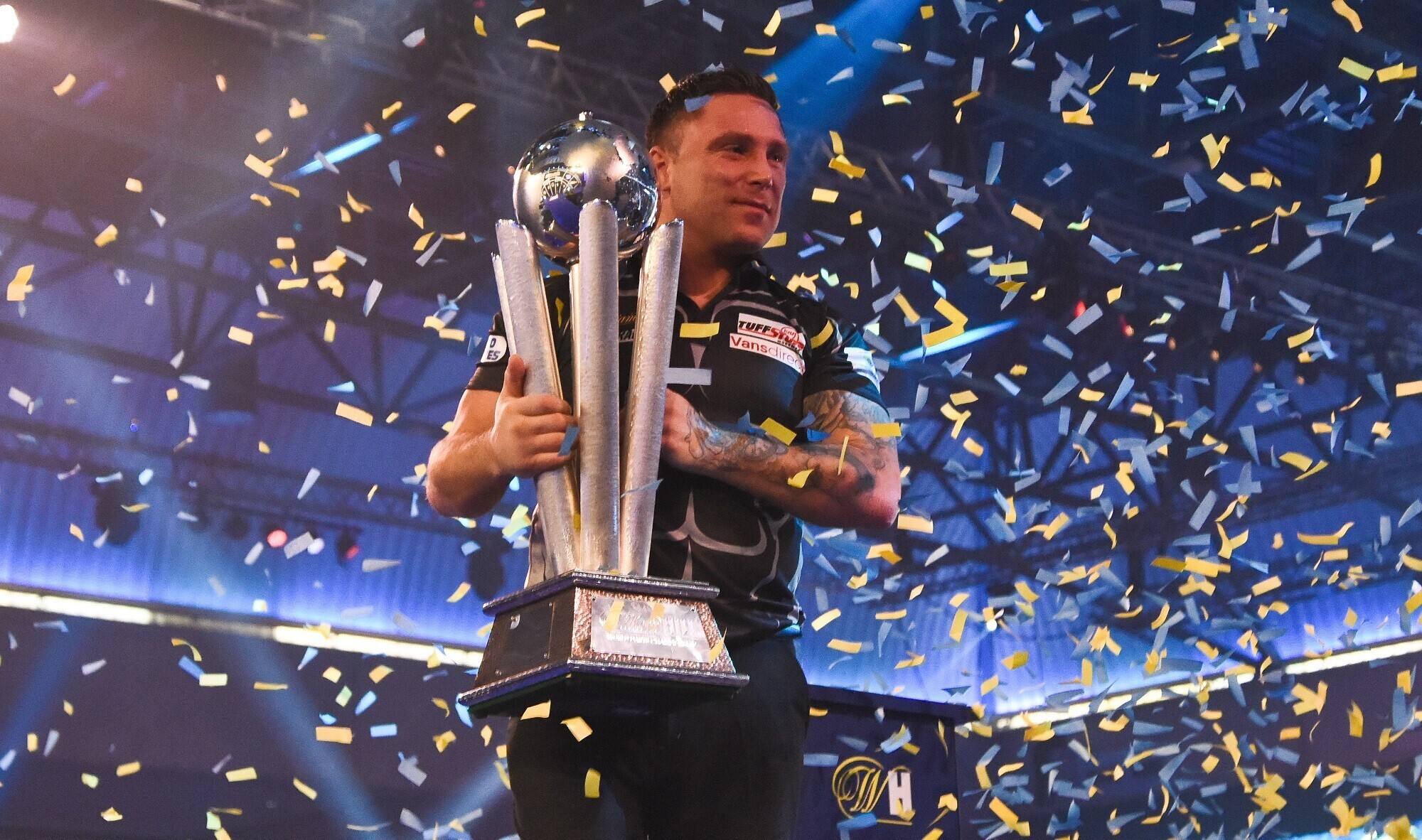 Gerwyn Price, World Darts Champion, holding the trophy